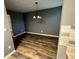 Cozy dining room featuring hardwood flooring and a classic chandelier at 5768 Windgate Ln, Lithonia, GA 30058