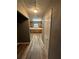 Hallway leading to kitchen with stainless steel appliances and oak cabinets at 5768 Windgate Lane Ln, Lithonia, GA 30058