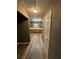 Hallway leading to kitchen with stainless steel appliances and oak cabinets at 5768 Windgate Ln, Lithonia, GA 30058