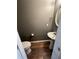 Cozy powder room featuring a pedestal sink, hardwood floors, and neutral paint at 5768 Windgate Ln, Lithonia, GA 30058