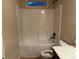 White bathroom with tub/shower combo and dark vanity at 2304 Northglenn Ct, Conyers, GA 30013