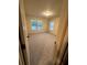 Bedroom with neutral carpet and walls, and two windows with blinds at 2304 Northglenn Ct, Conyers, GA 30013