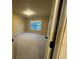 Neutral carpeted bedroom with two windows and interior door at 2304 Northglenn Ct, Conyers, GA 30013