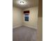 A cozy carpeted bedroom with a window, neutral walls, and white trim throughout at 2304 Northglenn Ct, Conyers, GA 30013