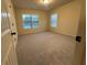 Carpeted bedroom with neutral walls and two windows with blinds at 2304 Northglenn Ct, Conyers, GA 30013