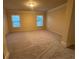 Spacious bonus room with neutral carpeting and ample natural light, perfect for a flexible living space at 2304 Northglenn Ct, Conyers, GA 30013