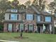 Beautiful two-story brick home with stone accents, a covered front porch, and manicured lawn at 2304 Northglenn Ct, Conyers, GA 30013
