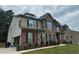 Two-story house with brick and stone facade with attached garage and green landscaping at 2304 Northglenn Ct, Conyers, GA 30013