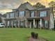 Spacious two-story brick and stone home with manicured lawn and inviting front porch at 2304 Northglenn Ct, Conyers, GA 30013