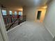 Hallway with wood and metal banister, neutral walls, and carpet at 2304 Northglenn Ct, Conyers, GA 30013