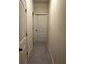 Neutral hallway showcasing paneled doors leading to various rooms, with a carpeted floor at 2304 Northglenn Ct, Conyers, GA 30013