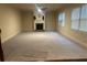 Bright living room has a fireplace with white mantel, a ceiling fan, and carpeted floors at 2304 Northglenn Ct, Conyers, GA 30013