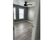 This bedroom features gray walls, a ceiling fan, and two windows that provide plenty of natural light at 3305 Wolverton Sw Ct, Conyers, GA 30094