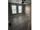 Bedroom with gray wood flooring, ceiling fan and bright natural light at 3305 Wolverton Sw Ct, Conyers, GA 30094