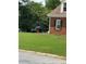 A black sporty car is parked on the lawn next to a two-story brick home at 3305 Wolverton Sw Ct, Conyers, GA 30094
