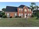Charming brick two-story home featuring a manicured front lawn and trimmed shrubs at 3305 Wolverton Sw Ct, Conyers, GA 30094