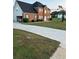 Traditional brick home with a well-maintained lawn and long concrete driveway at 3305 Wolverton Sw Ct, Conyers, GA 30094
