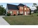 Lovely brick home showcasing a well-manicured lawn and an extended driveway at 3305 Wolverton Sw Ct, Conyers, GA 30094