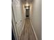 Long hallway with modern gray wood flooring leading to multiple rooms at 3305 Wolverton Sw Ct, Conyers, GA 30094