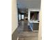 Open floorplan with dark flooring looking from the kitchen into a living room and staircase at 3305 Wolverton Sw Ct, Conyers, GA 30094