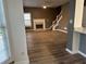 Inviting living room with fireplace, lots of natural light, and dark laminate flooring at 3305 Wolverton Sw Ct, Conyers, GA 30094