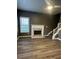Inviting living room with hardwood floors, fireplace, ceiling fan, and stairway at 3305 Wolverton Sw Ct, Conyers, GA 30094