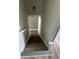 View down a staircase with newly installed gray wood flooring at 3305 Wolverton Sw Ct, Conyers, GA 30094