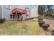 Backyard has a small deck and patio with a grassy area and shrubbery at 1657 Stilesboro Ridge Dr, Kennesaw, GA 30152
