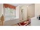 Bathroom featuring a soaking tub under a window and a separate glass shower at 1657 Stilesboro Ridge Dr, Kennesaw, GA 30152