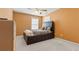 Cozy bedroom with an orange painted accent wall featuring a full sized bed at 1657 Stilesboro Ridge Dr, Kennesaw, GA 30152
