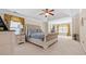 Bright primary bedroom features plush carpet, tufted headboard, and stylish window treatments at 1657 Stilesboro Ridge Dr, Kennesaw, GA 30152
