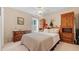 Cozy bedroom with neutral walls, a ceiling fan, and classic wooden furniture for a comfortable and inviting atmosphere at 1657 Stilesboro Ridge Dr, Kennesaw, GA 30152