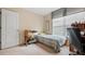 Small bedroom with natural light, neutral walls, carpet flooring, and a twin bed with a desk for study at 1657 Stilesboro Ridge Dr, Kennesaw, GA 30152