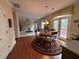 Open dining area features a round table with a decorative rug, connecting to the living room and outdoor patio at 1657 Stilesboro Ridge Dr, Kennesaw, GA 30152