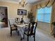 Formal dining room with elegant decor, chandelier, and large window dressed with valance and drapes at 1657 Stilesboro Ridge Dr, Kennesaw, GA 30152