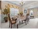 Elegant dining room featuring a decorative chandelier, wainscoting, and ornate curtains at 1657 Stilesboro Ridge Dr, Kennesaw, GA 30152
