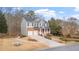 Traditional two-story home featuring a brick facade, a front porch, and a two-car garage at 1657 Stilesboro Ridge Dr, Kennesaw, GA 30152