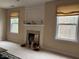 Fireplace detail with decorative mantel, flanked by windows and seasonal decorations creating a warm atmosphere at 1657 Stilesboro Ridge Dr, Kennesaw, GA 30152