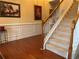 Elegant foyer with hardwood floors, staircase, and decorative wall trim at 1657 Stilesboro Ridge Dr, Kennesaw, GA 30152