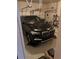 Garage with a parked black BMW car and storage shelves at 1657 Stilesboro Ridge Dr, Kennesaw, GA 30152