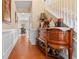 Inviting hallway with hardwood floors, decorative console, and staircase at 1657 Stilesboro Ridge Dr, Kennesaw, GA 30152