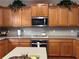 Well-lit kitchen featuring light wood cabinets, stainless steel appliances, and modern backsplash at 1657 Stilesboro Ridge Dr, Kennesaw, GA 30152