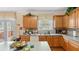 Traditional kitchen with light wood cabinets, neutral countertops, and lots of natural light from the nearby window and patio door at 1657 Stilesboro Ridge Dr, Kennesaw, GA 30152
