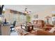Comfortable living room with a ceiling fan and large windows offering natural light at 1657 Stilesboro Ridge Dr, Kennesaw, GA 30152