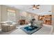 Bright living room featuring plush sofas, a fireplace, a ceiling fan and hardwood floors at 1657 Stilesboro Ridge Dr, Kennesaw, GA 30152