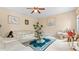 Bright living room featuring neutral walls, ceiling fan, and plush white furniture at 1657 Stilesboro Ridge Dr, Kennesaw, GA 30152