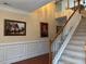 Staircase with carpeted steps, wood railing, and white balusters, complemented by elegant wall decor at 1657 Stilesboro Ridge Dr, Kennesaw, GA 30152