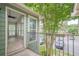 A balcony with an open view looking back into the sunroom with lots of natural light at 3205 Canyon Point Cir, Roswell, GA 30076