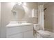Bright white bathroom with modern fixtures, subway tile, and a round vanity mirror at 3205 Canyon Point Cir, Roswell, GA 30076