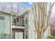 Balcony view with black railing on a condo featuring green siding and well-maintained landscaping at 3205 Canyon Point Cir, Roswell, GA 30076